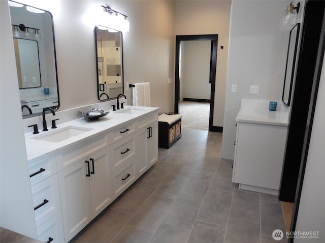 full bathroom with tile patterned flooring, double vanity, and a sink