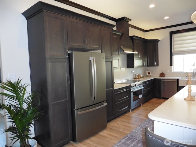 kitchen with premium range hood, appliances with stainless steel finishes, ornamental molding, and dark brown cabinets