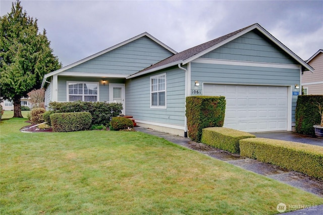 ranch-style home featuring a garage and a front lawn