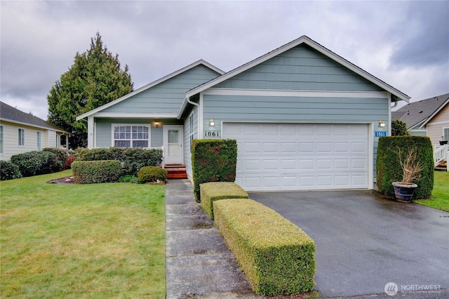 view of front facade with driveway, an attached garage, and a front yard