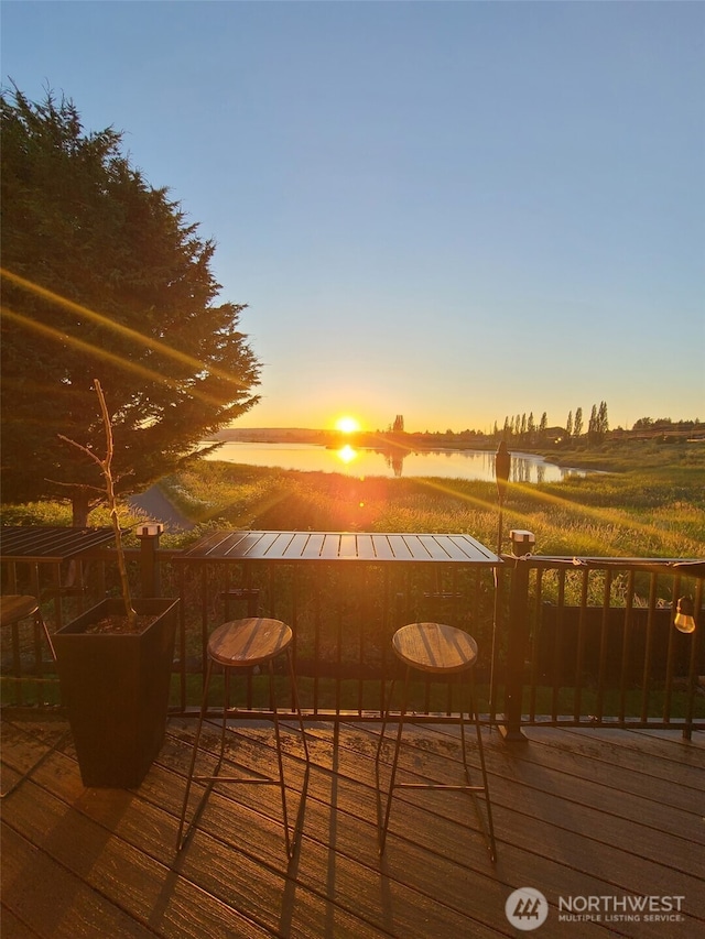 wooden terrace featuring a water view