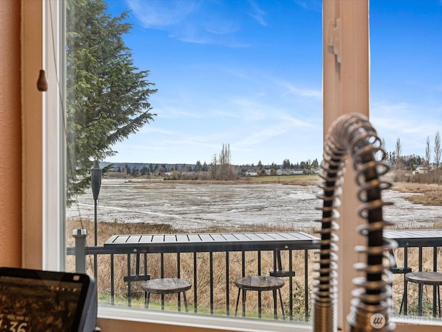 exterior space featuring a balcony and a rural view