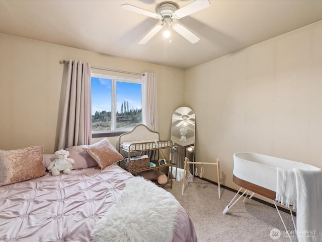 bedroom with a ceiling fan and carpet