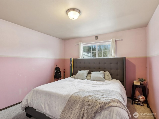 bedroom featuring baseboards and carpet