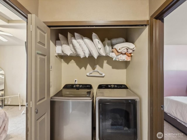 laundry area featuring washer and dryer, laundry area, and carpet flooring