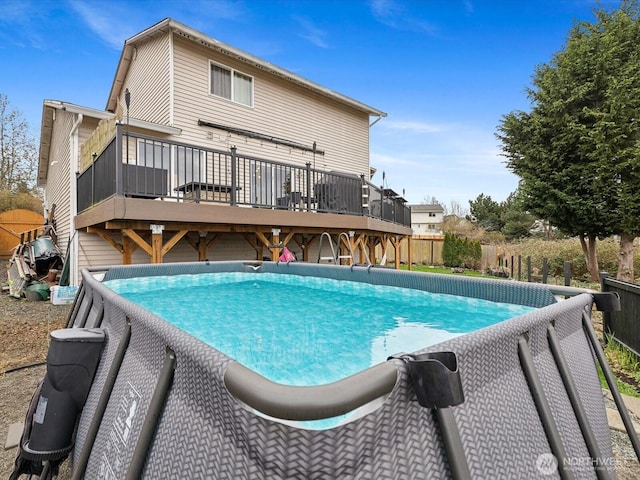 view of pool with a fenced in pool, a deck, and fence