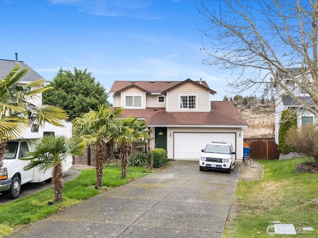 traditional-style home featuring a shingled roof, a front lawn, fence, concrete driveway, and a garage