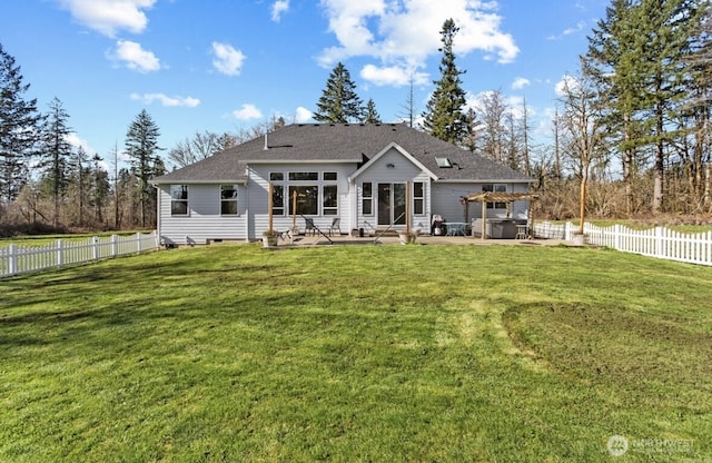 rear view of house with a fenced backyard, a yard, entry steps, and a patio