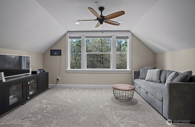 carpeted living room with vaulted ceiling, baseboards, and ceiling fan