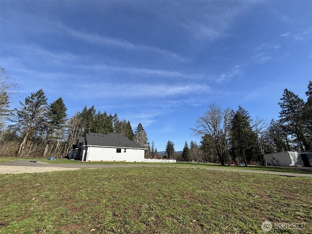 view of side of property featuring a yard