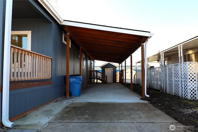 view of patio / terrace featuring fence, an outbuilding, and a shed