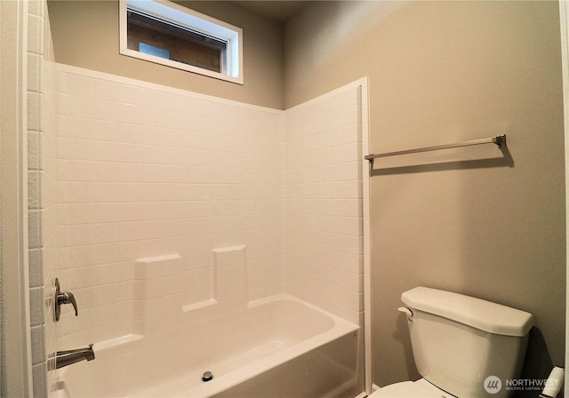 bathroom featuring bathing tub / shower combination and toilet