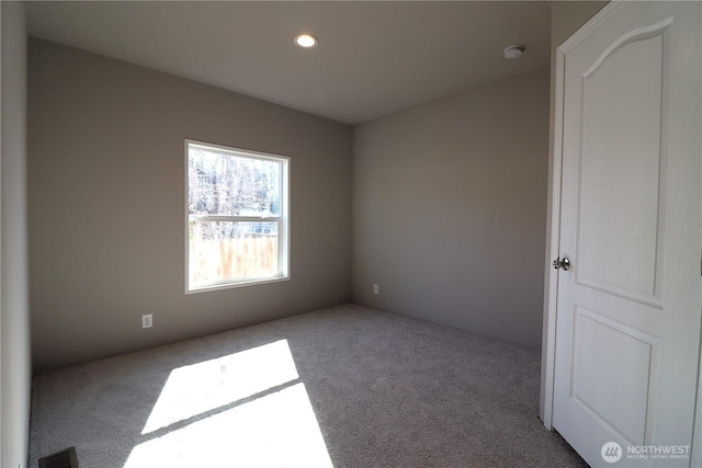 carpeted empty room featuring recessed lighting and visible vents