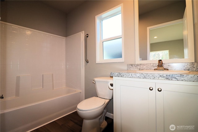 bathroom featuring shower / bathing tub combination, toilet, wood finished floors, and vanity