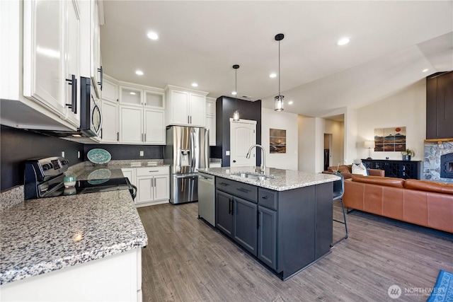 kitchen with a sink, dark wood-type flooring, white cabinets, and stainless steel appliances