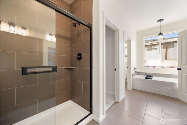 full bath featuring toilet, a stall shower, tile patterned flooring, and a bath