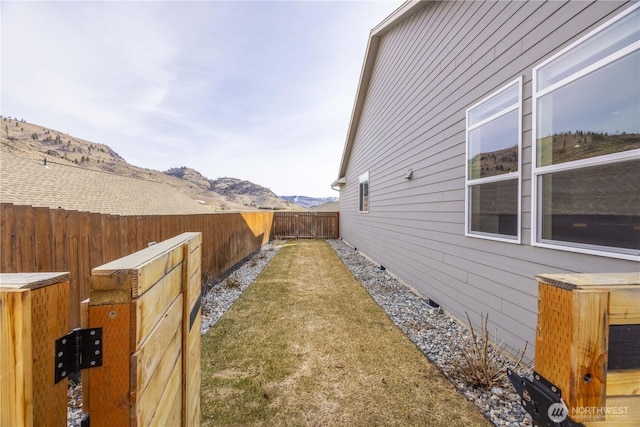 view of home's exterior featuring a mountain view and a fenced backyard