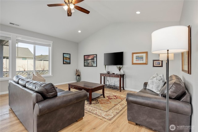 living area featuring a ceiling fan, baseboards, visible vents, lofted ceiling, and light wood-type flooring