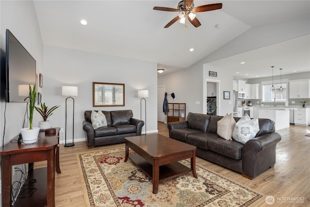 living room with recessed lighting, washer / clothes dryer, lofted ceiling, and light wood finished floors