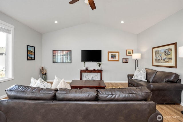 living room with lofted ceiling, baseboards, light wood-type flooring, and ceiling fan