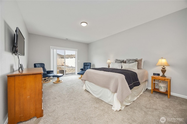 carpeted bedroom with access to outside and baseboards