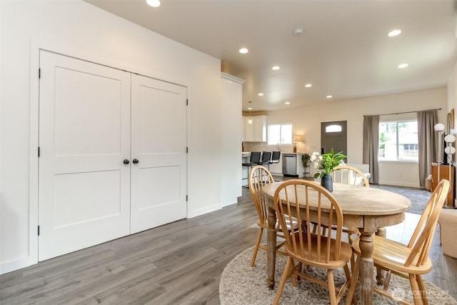 dining space with recessed lighting, baseboards, and wood finished floors