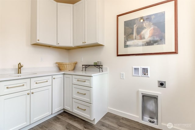 laundry room featuring washer hookup, a sink, wood finished floors, cabinet space, and hookup for an electric dryer