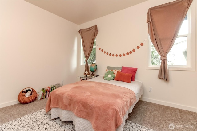 bedroom featuring baseboards and carpet flooring