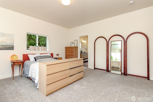 bedroom with light colored carpet and baseboards