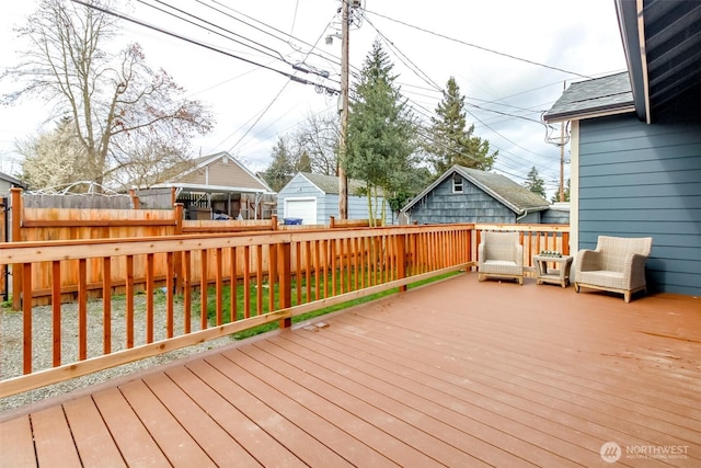 wooden deck featuring fence and a garage