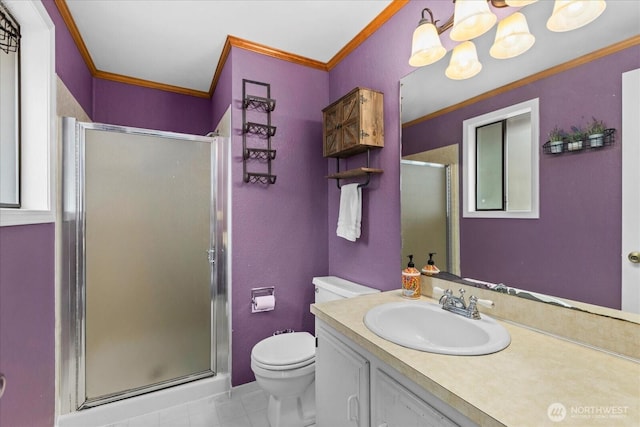 bathroom with a stall shower, toilet, crown molding, and vanity