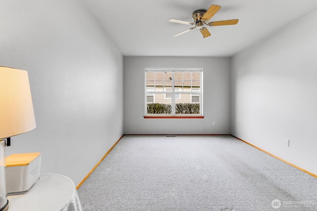 unfurnished room featuring baseboards, a ceiling fan, and carpet floors