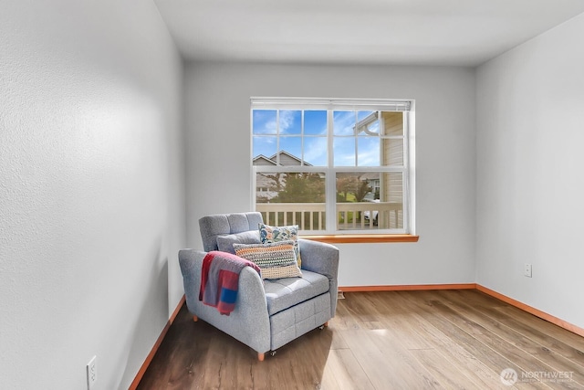 sitting room with wood finished floors and baseboards