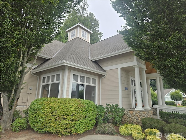 view of front of home with a shingled roof