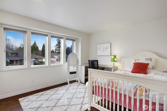 bedroom featuring baseboards and wood finished floors