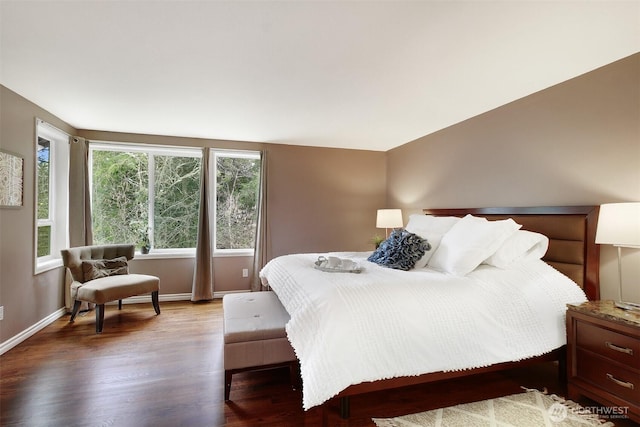 bedroom with wood finished floors and baseboards