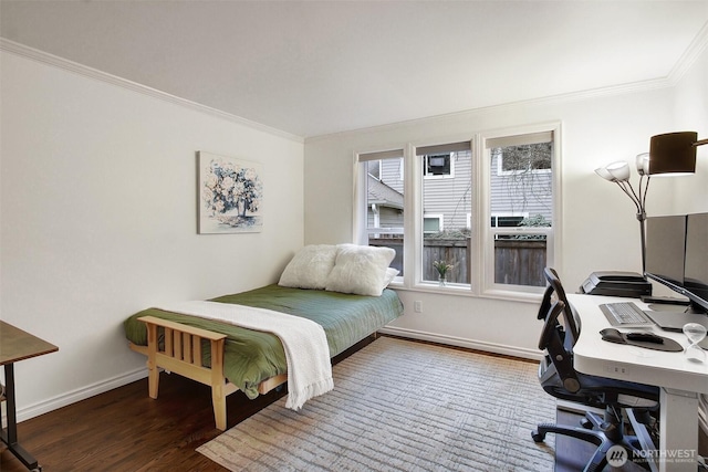 bedroom featuring crown molding, baseboards, and wood finished floors