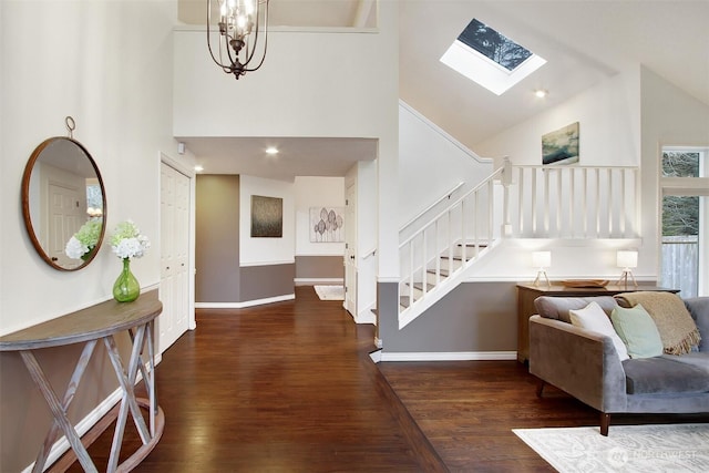 entrance foyer with high vaulted ceiling, wood finished floors, and stairs