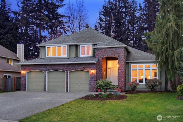 view of front of property with brick siding, roof with shingles, concrete driveway, and a front lawn