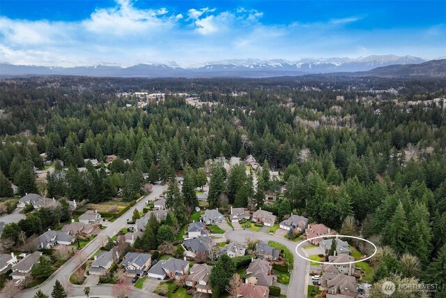 bird's eye view with a forest view, a mountain view, and a residential view