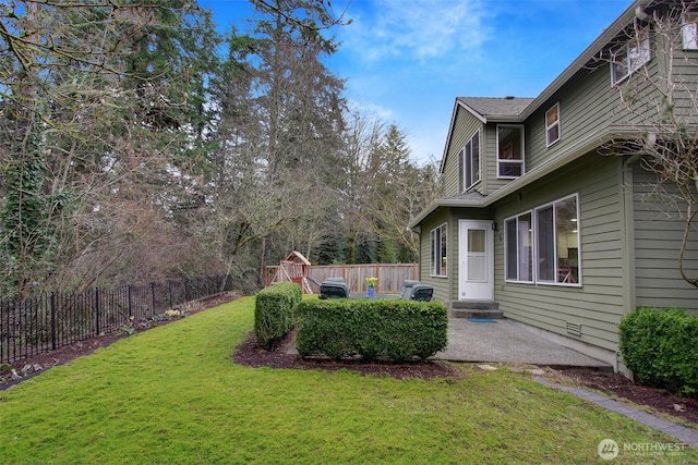 view of yard with a patio, a fenced backyard, and entry steps