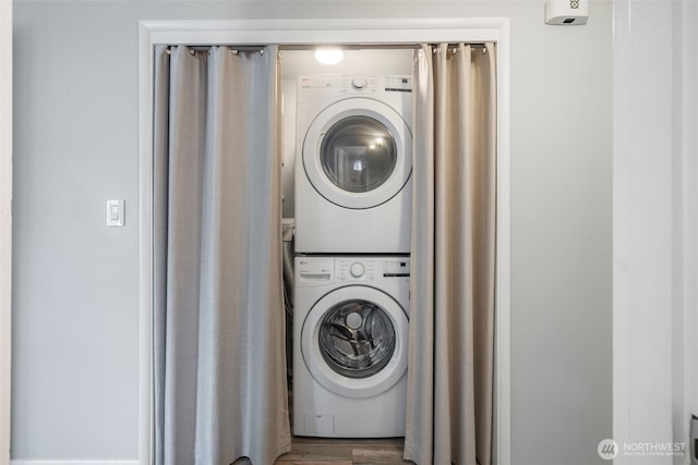 laundry area with laundry area and stacked washer / drying machine