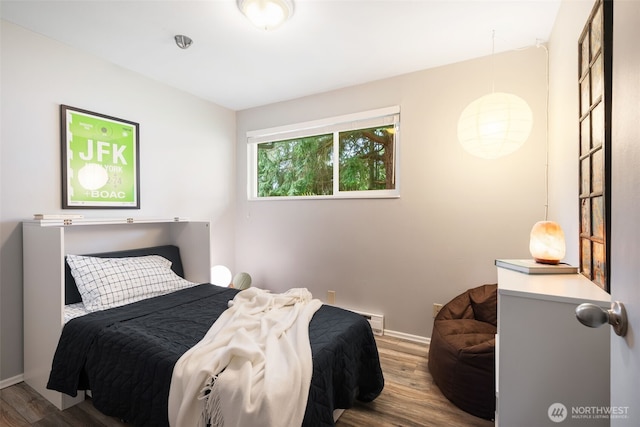 bedroom featuring wood finished floors and baseboards