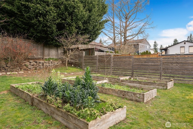 view of yard featuring a vegetable garden and fence