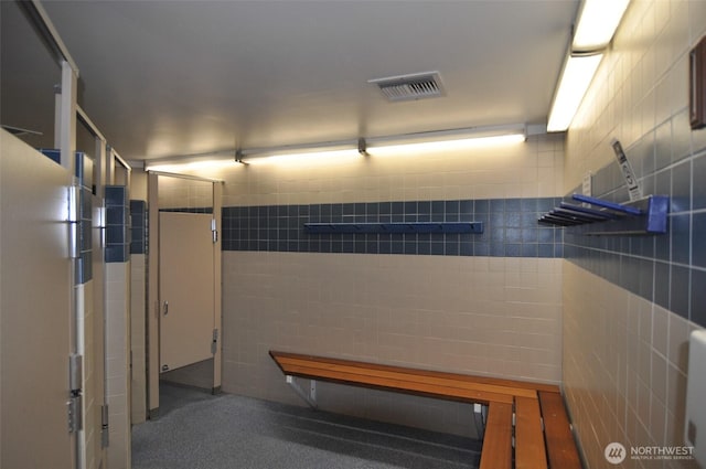 interior space featuring tile walls and visible vents