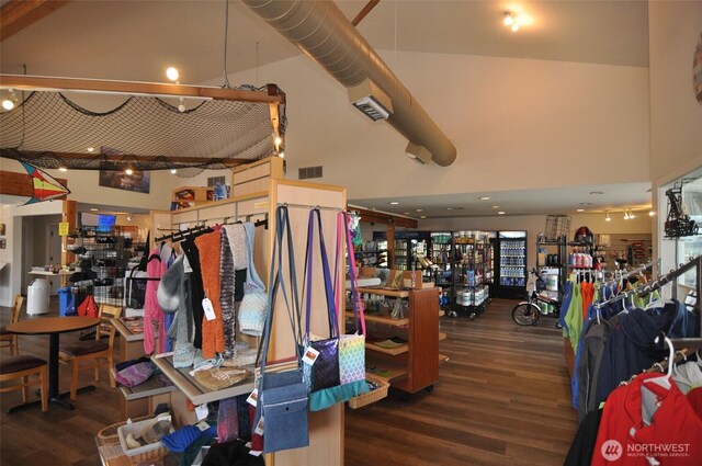 interior space with visible vents, wood finished floors, and a towering ceiling