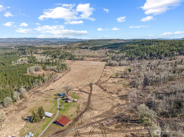 aerial view featuring a mountain view and a view of trees