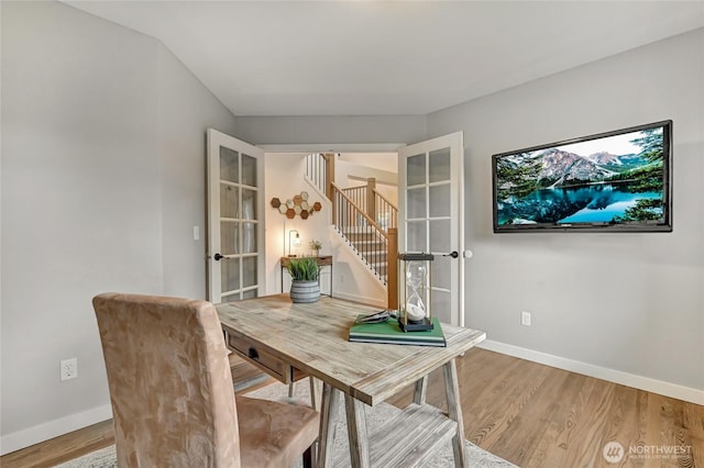 office area with baseboards and light wood-style floors