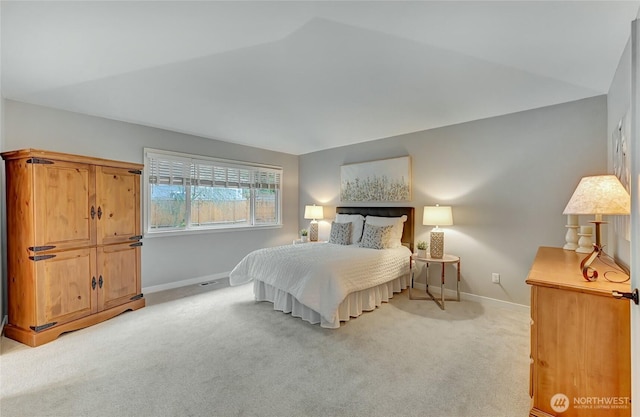 bedroom featuring baseboards and light colored carpet