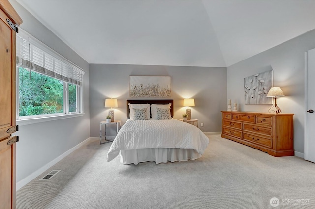 bedroom featuring vaulted ceiling, carpet, visible vents, and baseboards